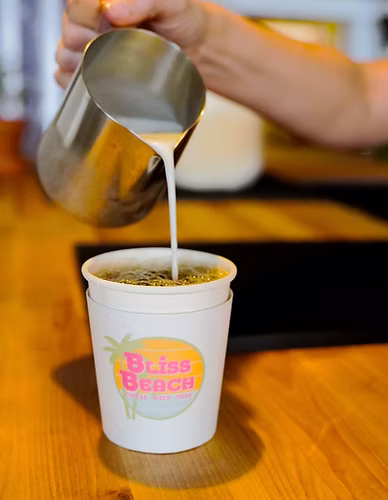 Pouring cream into coffee